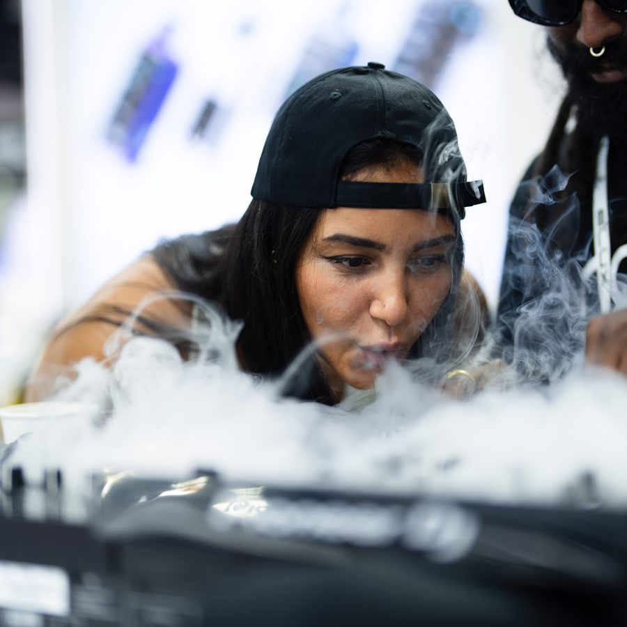 Close-up at a trade fair booth with dramatic smoke effect, photographed by Pixer